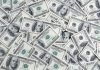 background-hundred-dollars-scattered-table_76263-6