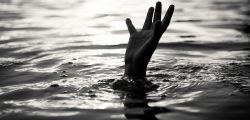 Black and white of Drowning victims Hand of drowning man needing help. Failure and rescue concept.