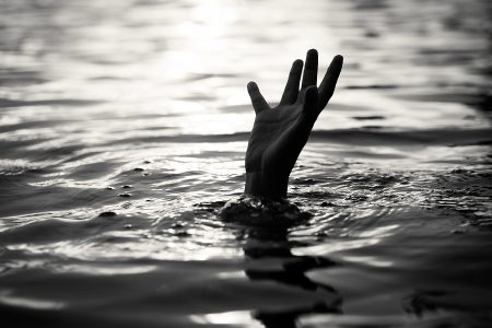 Black and white of Drowning victims Hand of drowning man needing help. Failure and rescue concept.