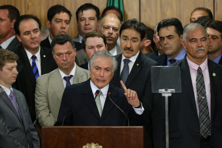 Michel Temer, Brazil's acting president, center, speaks during an event in Brasilia, Brazil, on Thursday, May 12, 2016. Temer has been the number two to President Dilma Rousseff of Brazil and now, with her temporary ouster, takes charge, buoyed by an almost evangelical market faith in him, as seen by the real's spike -- the world's best-performing currency this year -- and bond yield's plunge. It is widely expected that Rousseff will not return to power. Photographer: Lula Marques/Bloomberg via Getty Images