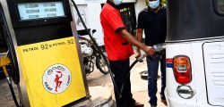 A worker fills the tank of an auto rickshaw at a petrol station in Colombo on February 18, 2022. (Photo by Ishara S. KODIKARA / AFP)