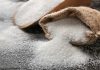 Sack with pure sugar on table
