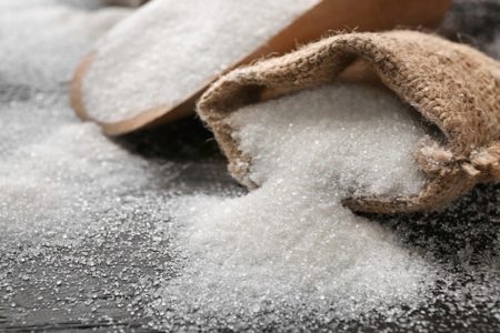 Sack with pure sugar on table
