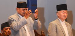 President Ram Baran Yadav (L) presents the country's new constitution next to Chairman of the Constituent Assembly Subhas Newang (R) at a special function in Kathmandu on September 20, 2015. Nepal on September 20 adopted a new constitution aimed at bolstering its transformation to a peaceful democracy after decades of instability and a long civil war, even as protests raged over its terms. 
Photo: Bijay Rai/ Nagarik/ Republica/
