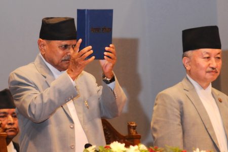 President Ram Baran Yadav (L) presents the country's new constitution next to Chairman of the Constituent Assembly Subhas Newang (R) at a special function in Kathmandu on September 20, 2015. Nepal on September 20 adopted a new constitution aimed at bolstering its transformation to a peaceful democracy after decades of instability and a long civil war, even as protests raged over its terms. 
Photo: Bijay Rai/ Nagarik/ Republica/