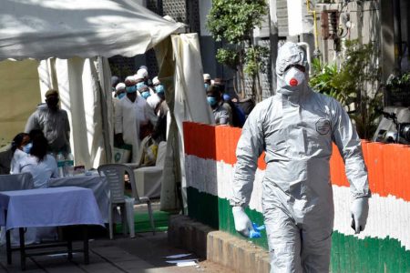 NEW DELHI, INDIA - MARCH 31: A bus driver in a protective suit before ferrying people who took part in a Tablighi Jamaat function earlier this month to a quarantine facility amid concerns of infection, on day 7 of the 21 day nationwide lockdown imposed by PM Narendra Modi to check the spread of coronavirus, at Nizamuddin West on March 31, 2020 in New Delhi, India. (Photo by Ajay Aggarwal/Hindustan Times)