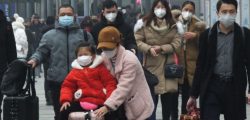 YICHANG, CHINA - JANUARY 21 2020: Travelers wearing protective masks walk outside a railway station in Yichang in central China's Hubei province Tuesday, Jan. 21, 2020. China has stepped up the measures to control the spread of the new coronavirus that has infected hundreds of people in China.