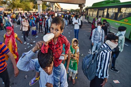 Ghaziabad: Migrants wait to board buses to their native villages during a nationwide lockdown, imposed in the wake of coronavirus pandemic at Kaushambi, in Ghaziabad, Saturday, March 28, 2020. (PTI Photo/Manvender Vashist)(PTI28-03-2020_000311A)
