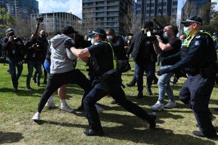 Police scuffle with protesters during an anti-lockdown protest in Melbourne, Saturday, September 5, 2020. Police have arrested anti-lockdown protesters amid violent scuffles in Melbourne as the state reports 11 more COVID-19 deaths and 76 fresh cases. (AAP Image/Erik Anderson) NO ARCHIVING