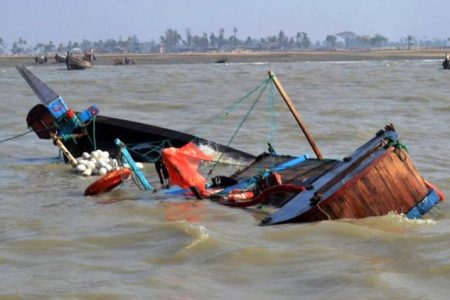 In this handout photograph released by the Bangladesh Coast Guard on January 29, 2015, the sinking boat which was carrying migrants headed for Malaysia, drifts in the waters off Kutubdia, in the Cox's Bazaar District.  Dozens of people are missing after an overloaded fishing trawler carrying migrants to Malaysia sank in strong currents off the coast of Bangladesh, officials said.    AFP PHOTO/ Bangladesh Coast Guard
----EDITORS NOTE---- RESTRICTED TO EDITORIAL USE - MANDATORY CREDIT  - "AFP PHOTO / BANGLADESH COAST GUARD" - NO MARKETING NO ADVERTISING CAMPAIGNS - DISTRIBUTED AS A SERVICE TO CLIENTS-----