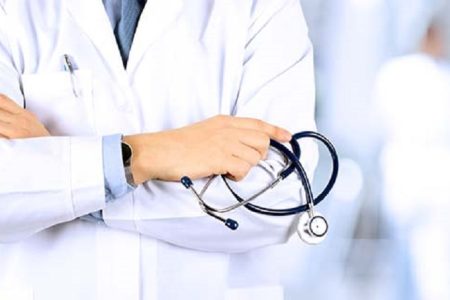 Portrait an unknown male doctor holding a stethoscope behind