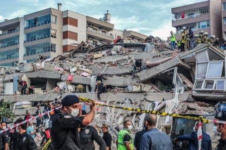 Rescuers search for survivors at a collapsed building after a powerful earthquake struck Turkey's western coast and parts of Greece, in Izmir, on October 30, 2020. - A powerful earthquake hit Turkey and Greece on October 30, killing at least six people, levelling buildings and creating a sea surge that flooded streets near the Turkish resort city of Izmir. (Photo by MERT CAKIR / AFP) / Turkey OUT (Photo by MERT CAKIR/AFP via Getty Images)