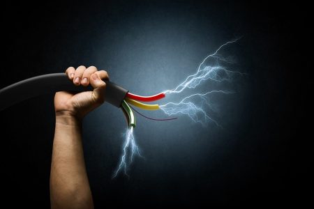 Close up image of human hand holding cable