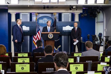 WASHINGTON, DC - AUGUST 23: President Donald Trump and FDA Commissioner Stephen Hahn looks on as Health and Human Services Secretary, Alex Azar, addresses the media during a press conference in James S. Brady Briefing Room at the White House on on August 23, 2020 in Washington, DC. President Donald Trump announced that the Food and Drug Administration is issuing an emergency authorization for blood plasma as a coronavirus treatment The move by the FDA comes after President Trump accused the FDA of slow-walking the therapy to harm his reelection chances.(Photo by Pete Marovich/Getty Images)