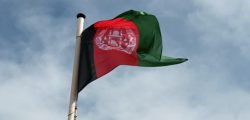 National flag of Afghanistan flying from a pole
