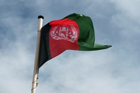 National flag of Afghanistan flying from a pole