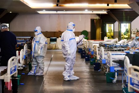 **EDS: RPT CORRECTS TYPO** New Delhi: Medics attend to a COVID-19 patients at Shehnai Banquet Hall, temporarily converted into an isolation ward, as coronavirus cases surge across the country, near Lok Nayak Jai Prakash (LNJP) Hospital in New Delhi, Tuesday, April 13, 2021. (PTI Photo/Manvender Vashist) (PTI04_13_2021_000116A)