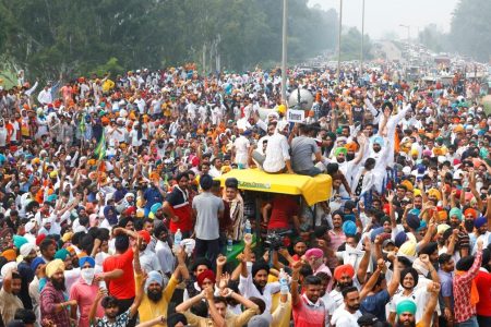 Farmers gesture as they block a national highway during a protest against farm bills passed by India's parliament, in Shambhu in the northern state of Punjab, India, September 25, 2020. REUTERS/Adnan Abidi