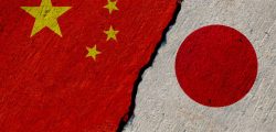 chinese and japan flags painted on cracked concrete wall, china and japan conflict or partnership concept
