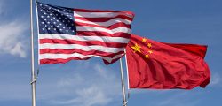 Symbolic of Sino-American relations, the flag of the United States of America and the flag of the Republic of China fly together on flag poles next to each other on a sunny, windy day.