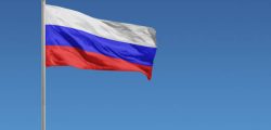 Flag of Russia in front of a clear blue sky