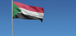 Flag of Sudan in front of a clear blue sky
