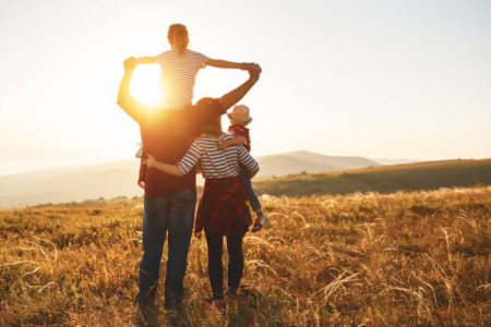 Happy family: mother, father, children son and  daughter on nature  on sunset