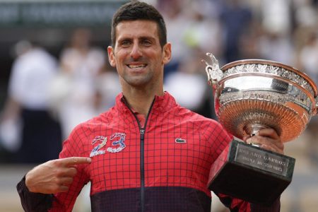 Serbia's Novak Djokovic points at 23 on his garment as he celebrates winning the men's singles final match of the French Open tennis tournament against Norway's Casper Ruud in three sets, 7-6, (7-1), 6-3, 7-5, at the Roland Garros stadium in Paris, Sunday, June 11, 2023. Djokovic won his record 23rd Grand Slam singles title, breaking a tie with Rafael Nadal for the most by a man. (AP Photo/Thibault Camus)