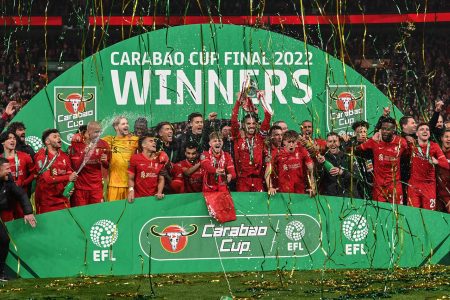 Jordan Henderson #14 of Liverpool and his team mates lift the Carabao Cup after winning on penalties  in London, United Kingdom on 2/27/2022. (Photo by Craig Thomas/News Images/Sipa USA)