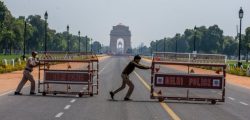 NEW DELHI, INDIA - MARCH 22: Indian policemen push barricades to place them in the center of a a road leading to historic India Gate,  during a one-day nationwide Janata (civil) curfew imposed as a preventive measure against the COVID-19 on March 22, 2020 in New Delhi, India. Death toll due to coronavirus in India reached seven on Sunday with three more fatalities as the country observed a "janta curfew" or public lockdown on the appeal of Prime Minister Narendara Modi. Besides placing under lockdown till March 31st, 75 districts with confirmed coronavirus cases , the government also decided to shut down train, metro and inter-state services to curb the spread of the global pandemic in India. (Photo by Yawar Nazir/Getty Images)