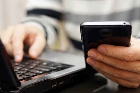 Teenager Addicted To The Internet And Social Media Using Phone And Laptop At The Same Time