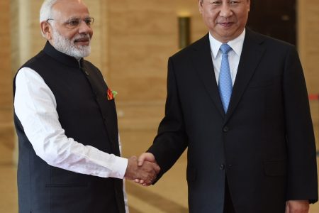 In this photo released by the Indian Ministry of External Affairs, Indian Prime Minister Narendra Modi, left, shakes hands with Chinese President Xi Jinping in Wuhan, China, Friday, April 27, 2018. The leaders of India and China met at a lakeside resort in central China on Friday amid tensions along their contested border and a rivalry for influence among their smaller neighbors that could determine dominance in Asia. (Indian Ministry of External Affairs via AP)