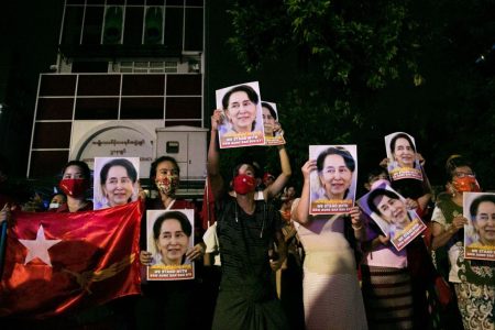 Supporters of the National League for Democracy (NLD) party hold portraits of Aung San Suu Kyi as they celebrate in front of the party's headquarters in Yangon on November 9, 2020, as NLD officials said they were confident of a landslide victory in the weekend's election. - Aung San Suu Kyi's ruling National League for Democracy said on November 9, 2020, it was confident of winning a landslide victory in Myanmar as official results trickled in following the weekend's coronavirus-disrupted election. Millions had lined up for hours to cast their ballots on November 8, 2020 -- only the second national election since the country emerged from outright military rule in 2011. (Photo by Sai Aung Main / AFP) (Photo by SAI AUNG MAIN/AFP via Getty Images)