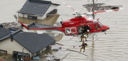 An aerial view shows a local resident being rescued from a submerged house by rescue workers using helicopter at a flooded area in Kurashiki, southern Japan, in this photo taken by Kyodo July 7, 2018. Mandatory credit Kyodo/via REUTERS ATTENTION EDITORS - THIS IMAGE WAS PROVIDED BY A THIRD PARTY. MANDATORY CREDIT. JAPAN OUT. NO COMMERCIAL OR EDITORIAL SALES IN JAPAN. - RC1B66111DD0