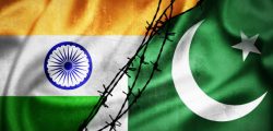 Grunge flags of India and Pakistan divided by barb wire illustration, concept of tense relations between India and Pakistan