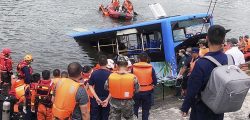 In this photo released by Xinhua News Agency, rescuers watch as a bus that fell into a lake is recovered in the Xixiu District of Anshun, southwestern China's Guizhou Province, Tuesday, July 7, 2020. Authorities say dozens were killed Tuesday when a bus ran through a roadside fence and plunged into a lake in the southwestern Chinese city. (Long Rui/Xinhua via AP)