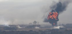 An explosion is seen over the Syrian town of Ras al-Ain as seen from the Turkish border town of Ceylanpinar, Sanliurfa province, Turkey, October 12, 2019. REUTERS/Stoyan Nenov - RC16E90D02E0