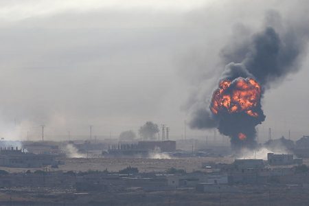 An explosion is seen over the Syrian town of Ras al-Ain as seen from the Turkish border town of Ceylanpinar, Sanliurfa province, Turkey, October 12, 2019. REUTERS/Stoyan Nenov - RC16E90D02E0