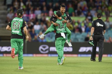CANBERRA, AUSTRALIA - DECEMBER 21: Sandeep Plamichhane of the Stars celebrates with team mates after taking the wicket of Shane Watson of the Thunder during the Sydney Thunder v Melbourne Stars Big Bash League Match at Manuka Oval on December 21, 2018 in Canberra, Australia. (Photo by Brett Hemmings/Getty Images)