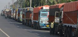 Indian truck drivers stay near their trucks parked close to the India-Nepal border at Panitanki, some 40 kms from Siliguri on December 2, 2015, during the ongoing dispute between Nepal and India. Scores of trucks have been stranded at a key border checkpoint for over two months following protests by ethnic minorities over the Himalayan nation's new constitution introduced in September. Movement across other border checkpoints has also slowed to a crawl, leading to a nationwide fuel crisis and short supplies of medicines. AFP PHOTO / Diptendu DUTTA