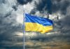 Ukraine flag. Ukrainian flag on black storm cloud sky. stormy weather