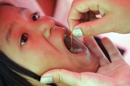 A child receives a dose of vitamin A in Guatemala City.