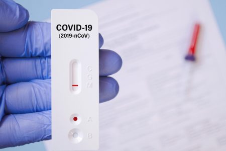Positive test result by using rapid test for COVID-19, quick fast antibody point of care testing.